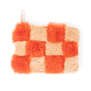 Peach colored and orange colored checkered sherling zipper pouch on white background