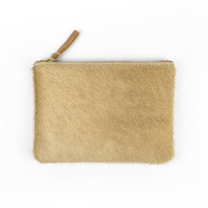 Caramel colored cowhide zipper pouch on white background
